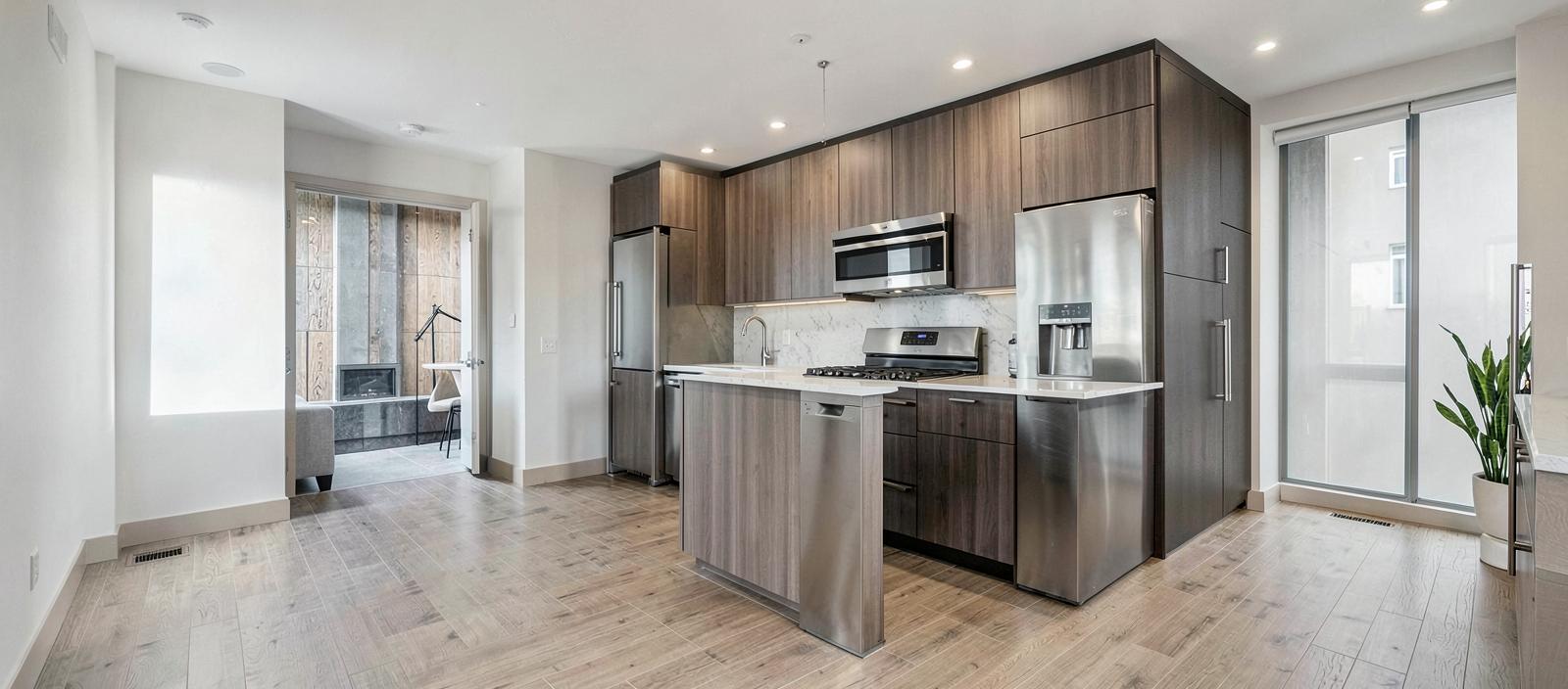 Newly renovated multi-family apartment interior with new appliances, cabinetry, and flooring